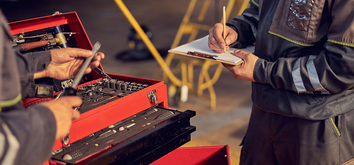 cropped head portrait men aircraft with tools hand another male doing notes clipboard