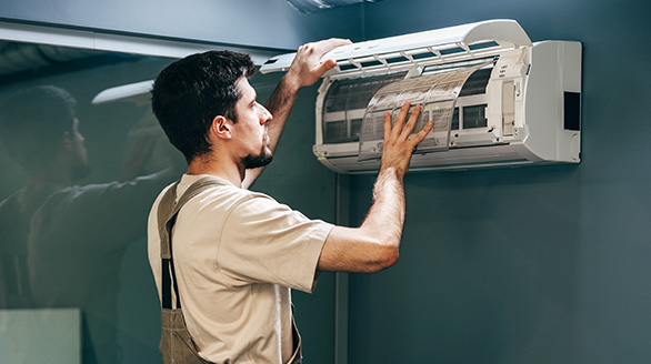 maintenance technician installs air conditioning unit indoors modern office environment